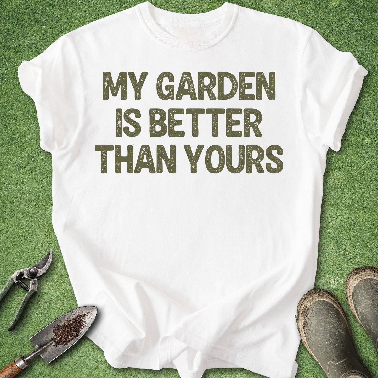 White t-shirt with 'My garden is better than yours' text on a green background with gardening tools.