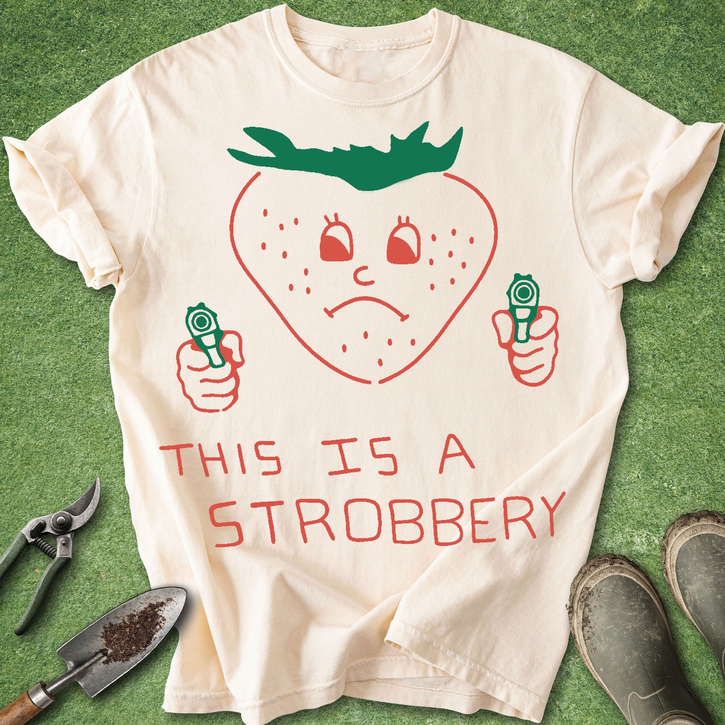 T-shirt with a strawberry graphic and text 'THIS IS A STROBBERY' on a green background