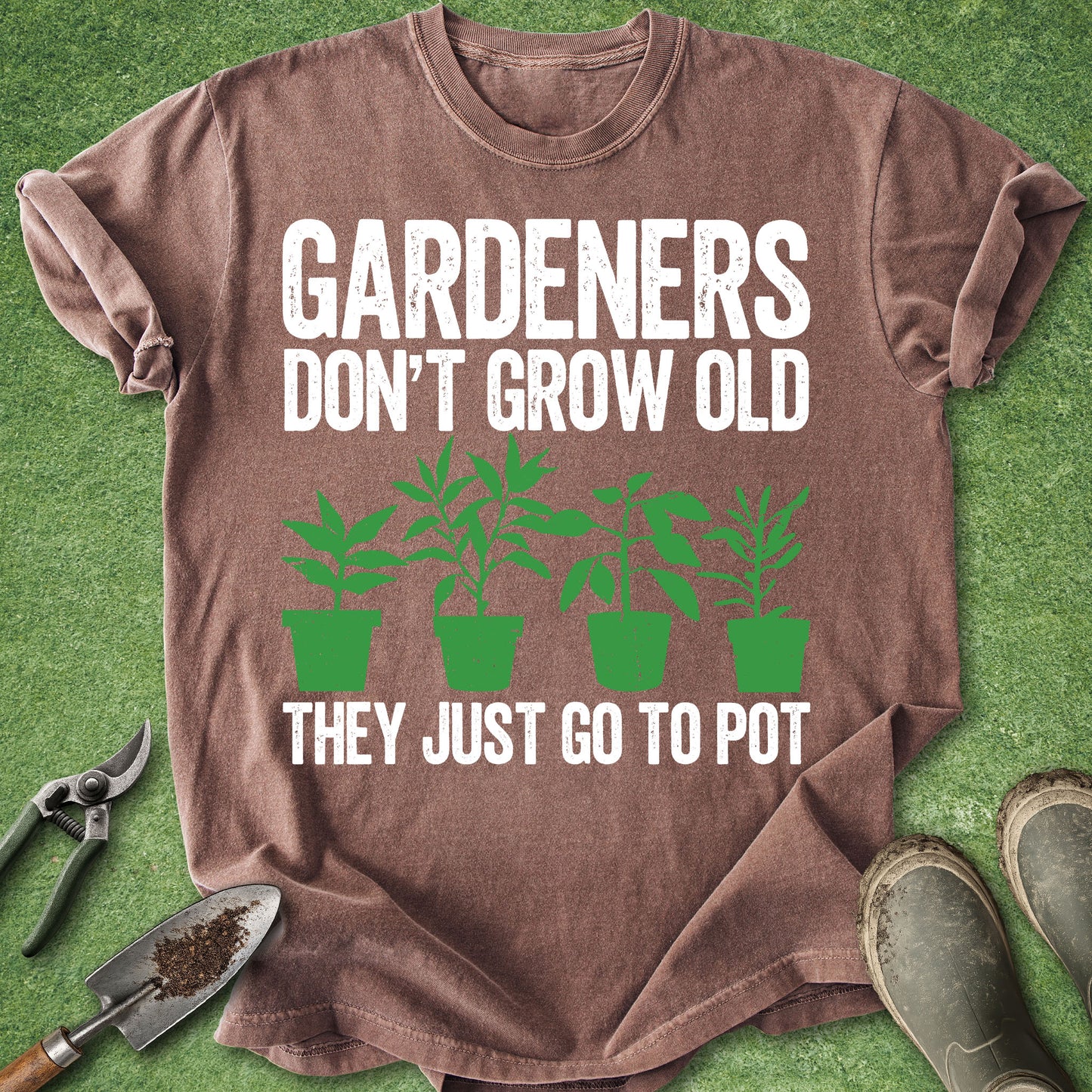 Comfort Colors espresso t-shirt featuring the phrase "Gardeners Don't Grow Old They Just Go to Pot" with four green potted plants in a minimalist vintage-style design.