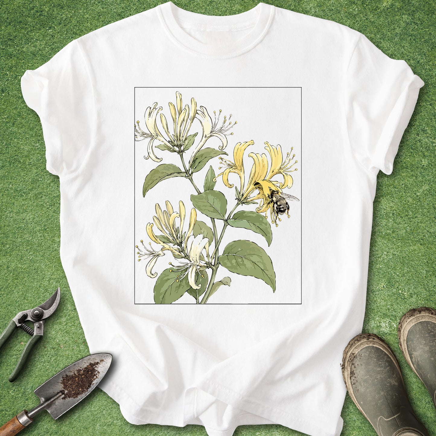 White t-shirt featuring a vintage botanical illustration of blooming honeysuckle flowers with a bumblebee collecting nectar.