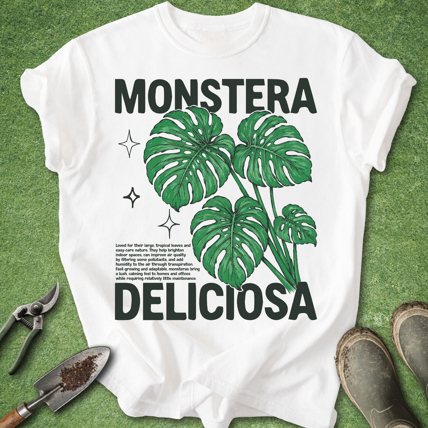 White t-shirt with 'Monstera Deliciosa' design on a green background