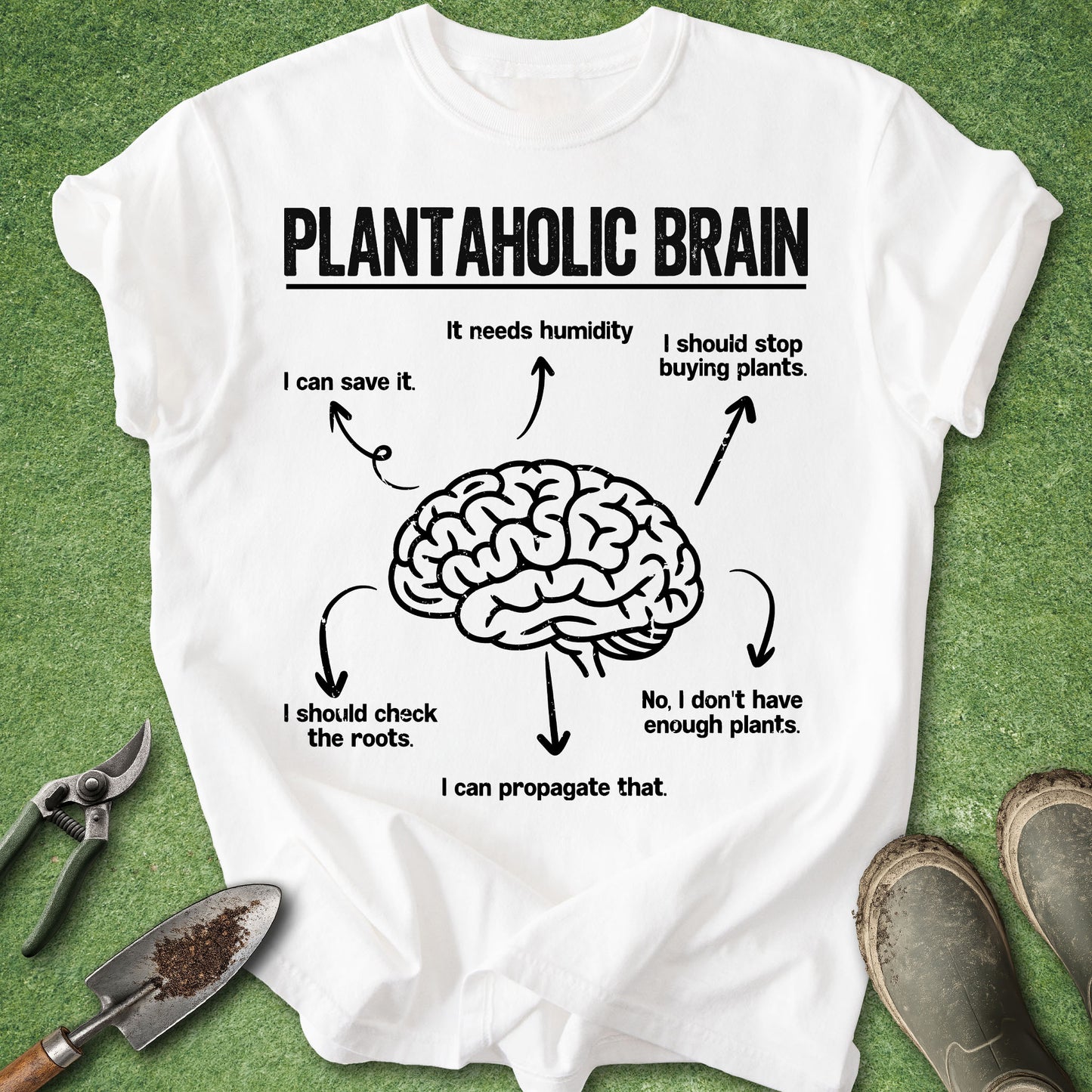 White t-shirt with a brain graphic and text on a green background with gardening tools.
