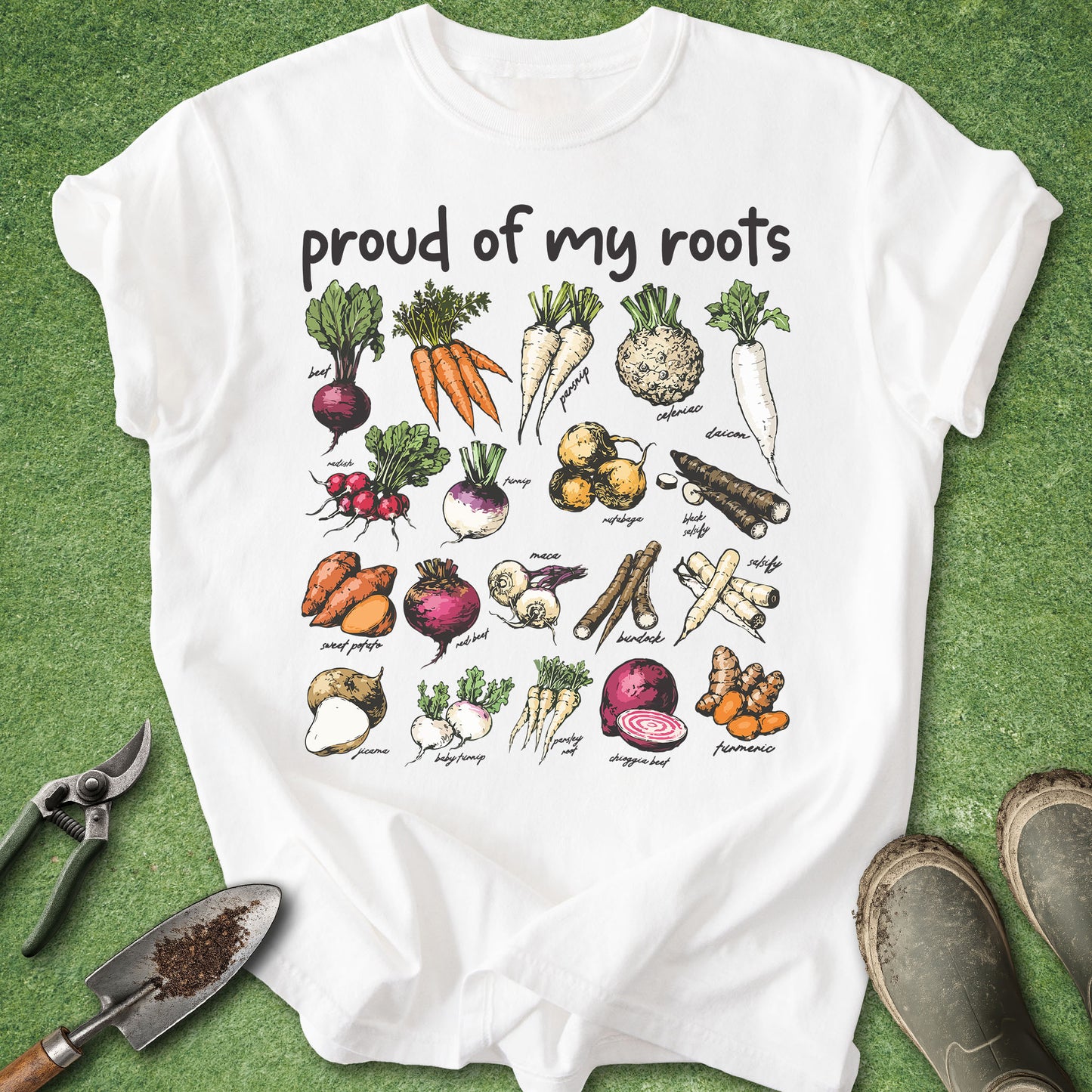 White t-shirt with vegetable illustrations and 'proud of my roots' text on a green background.