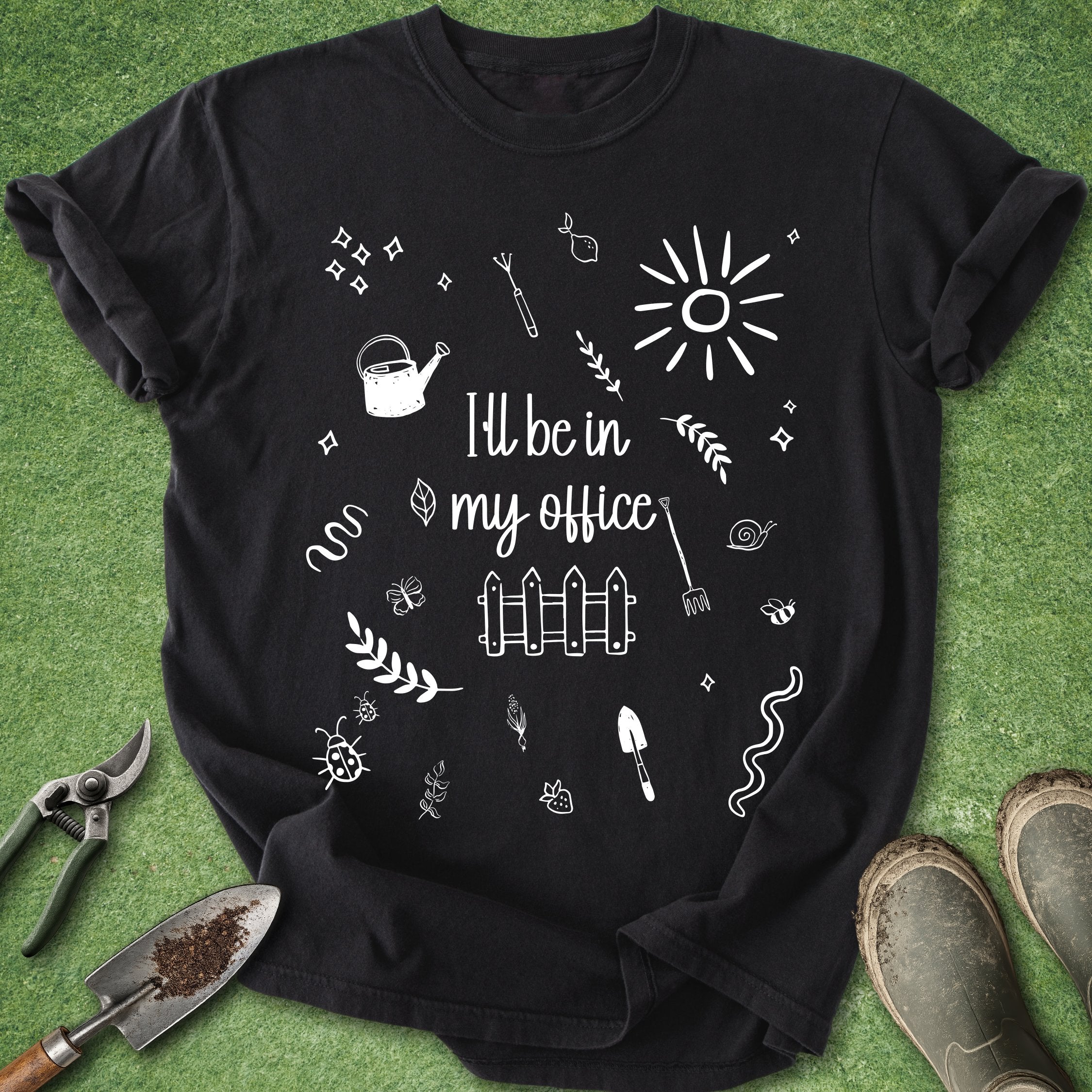 Black t-shirt with white graphics and text on a green grass background