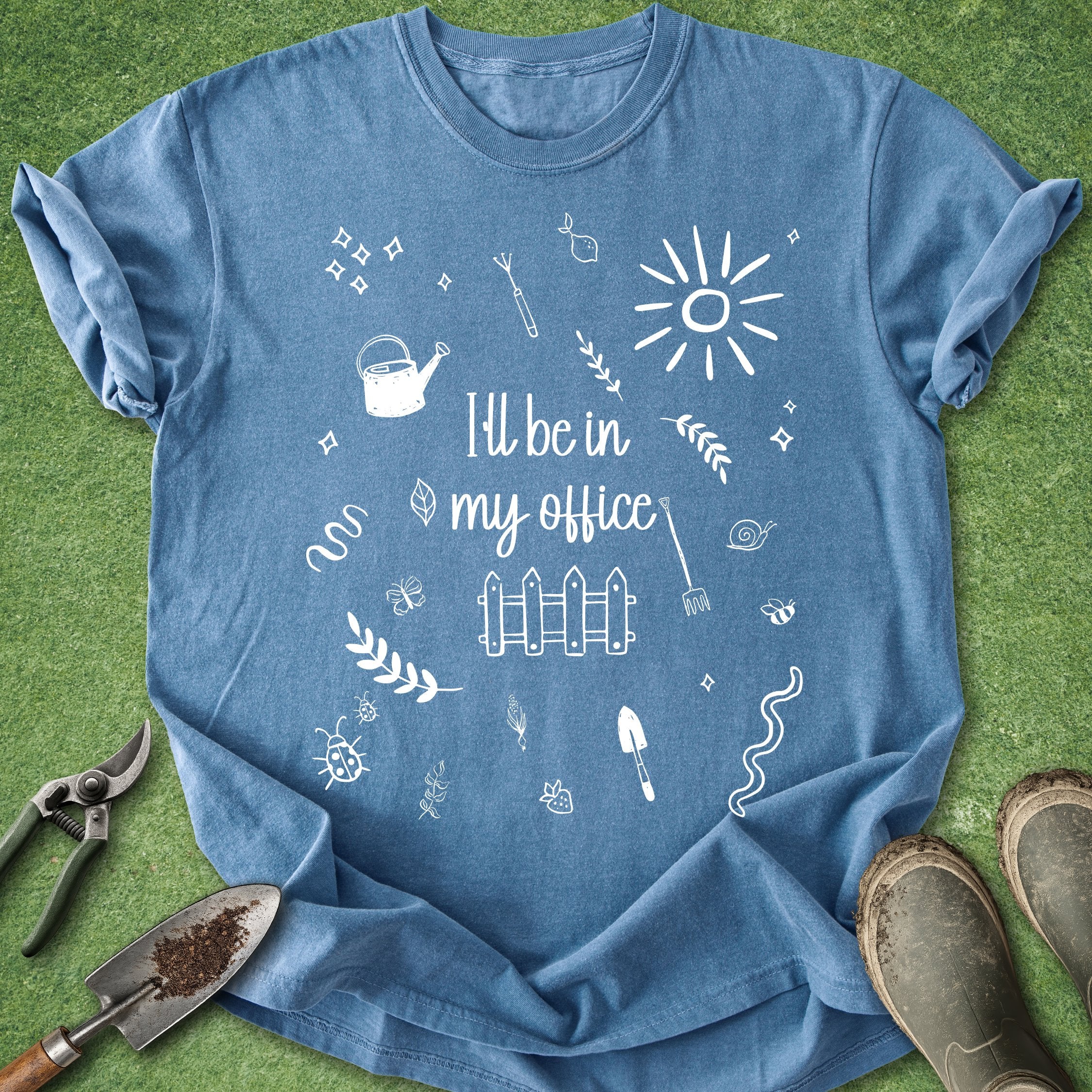 Blue t-shirt with white graphics and text on a green grass background