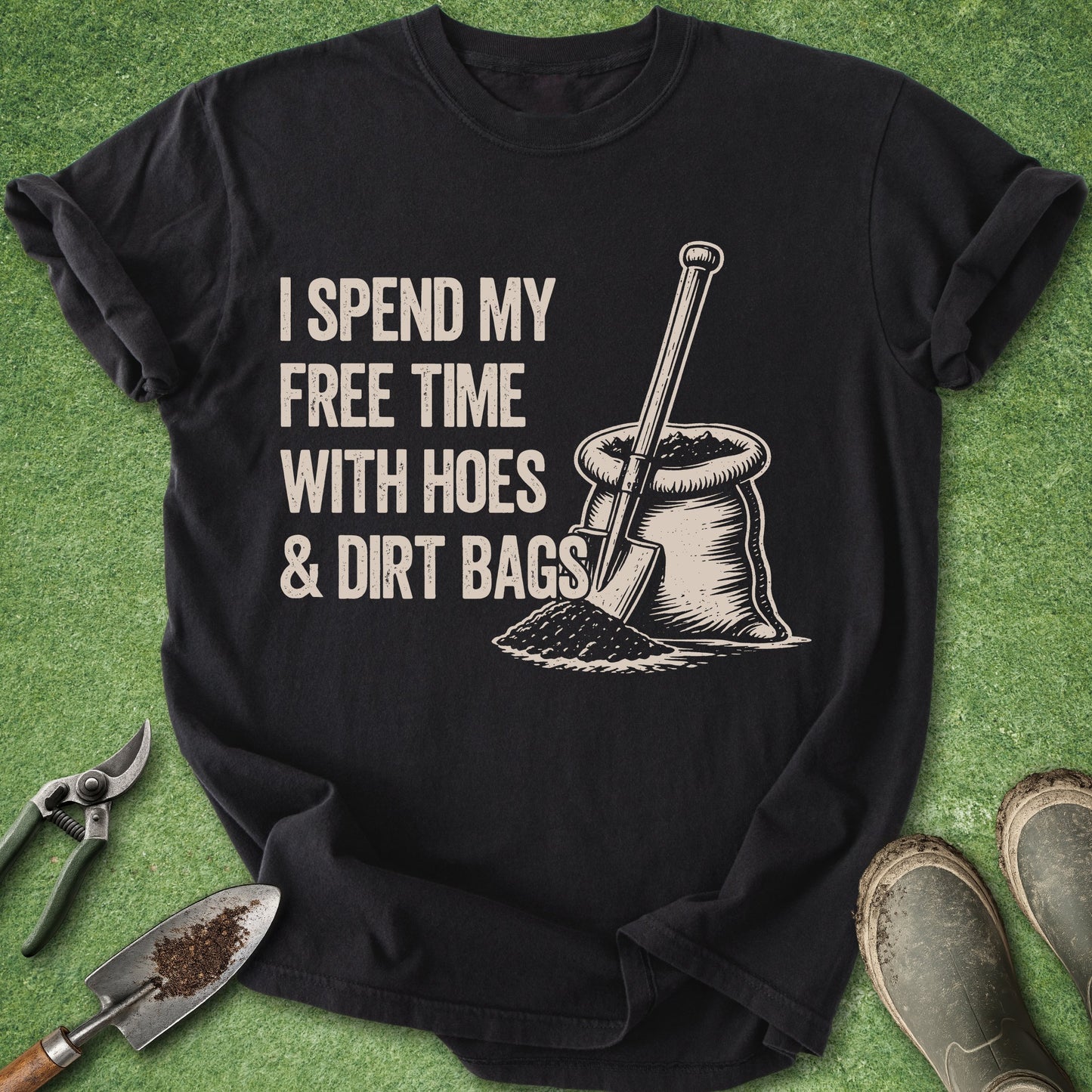 Black t-shirt with gardening-themed graphic and text on a green grass background