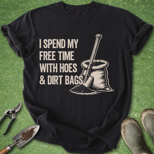 Black t-shirt with gardening-themed graphic and text on a green grass background
