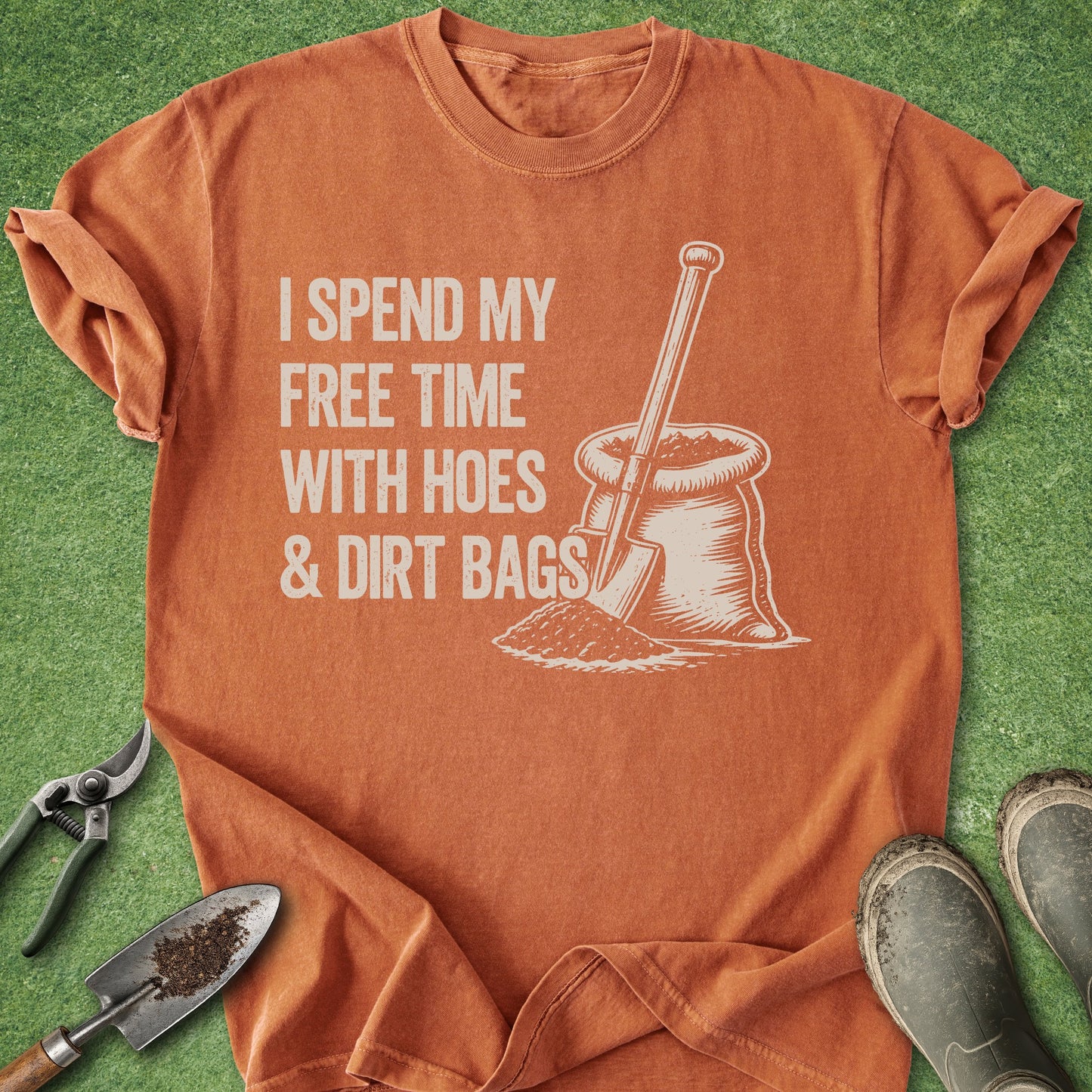 Orange t-shirt with graphic and text on a grass background