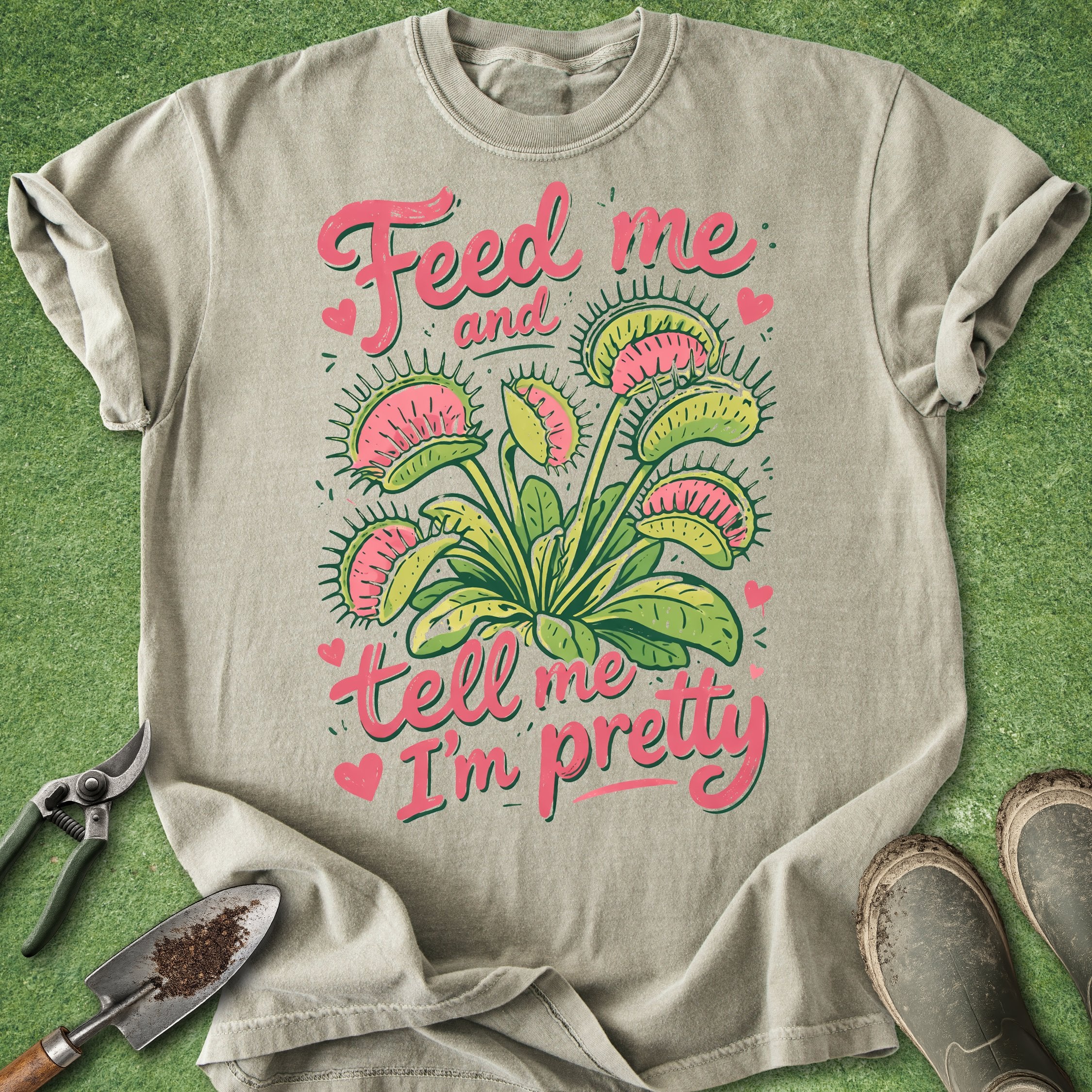 Beige t-shirt with plant graphic and text on a green background