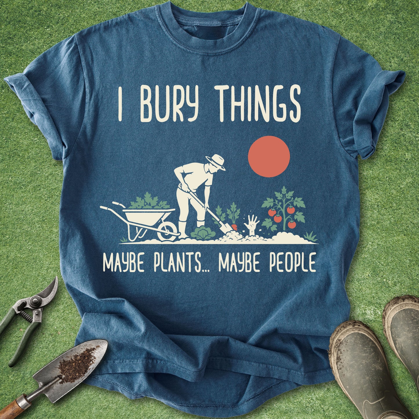 Blue t-shirt with gardening graphic and text on a grass background