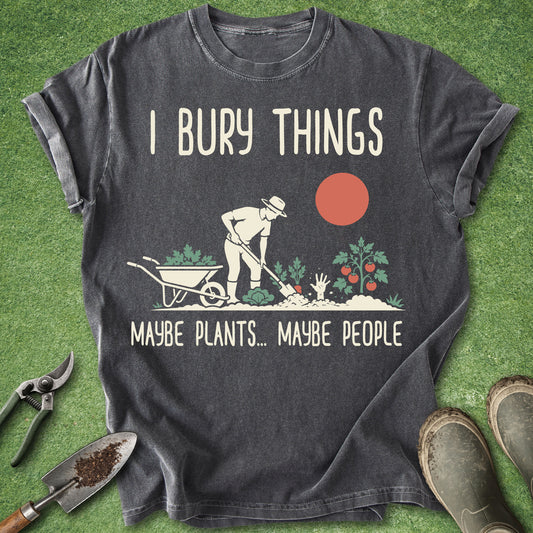 Gray t-shirt with gardening graphic and text on a grass background