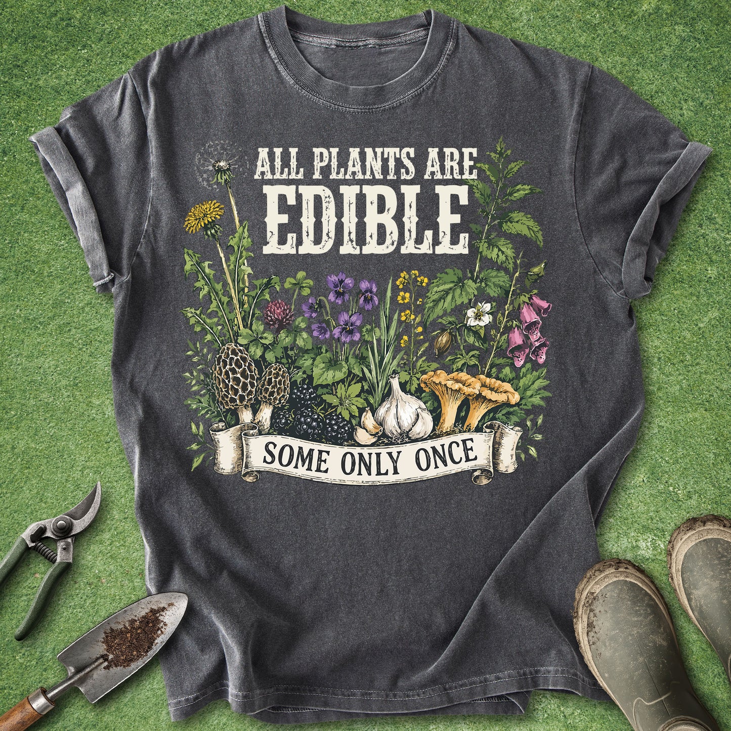 Comfort Colors pepper t-shirt featuring the phrase "All Plants Are Edible Some Only Once" with detailed illustrations of wild edible plants, mushrooms, berries, garlic, flowers, and foraging botanicals.