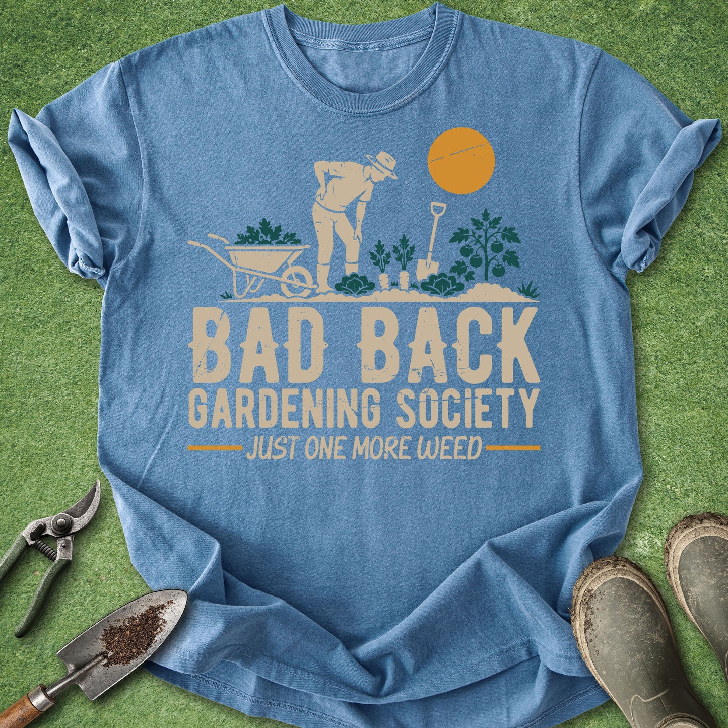 Blue t-shirt with 'Bad Back Gardening Society' graphic on a grass background