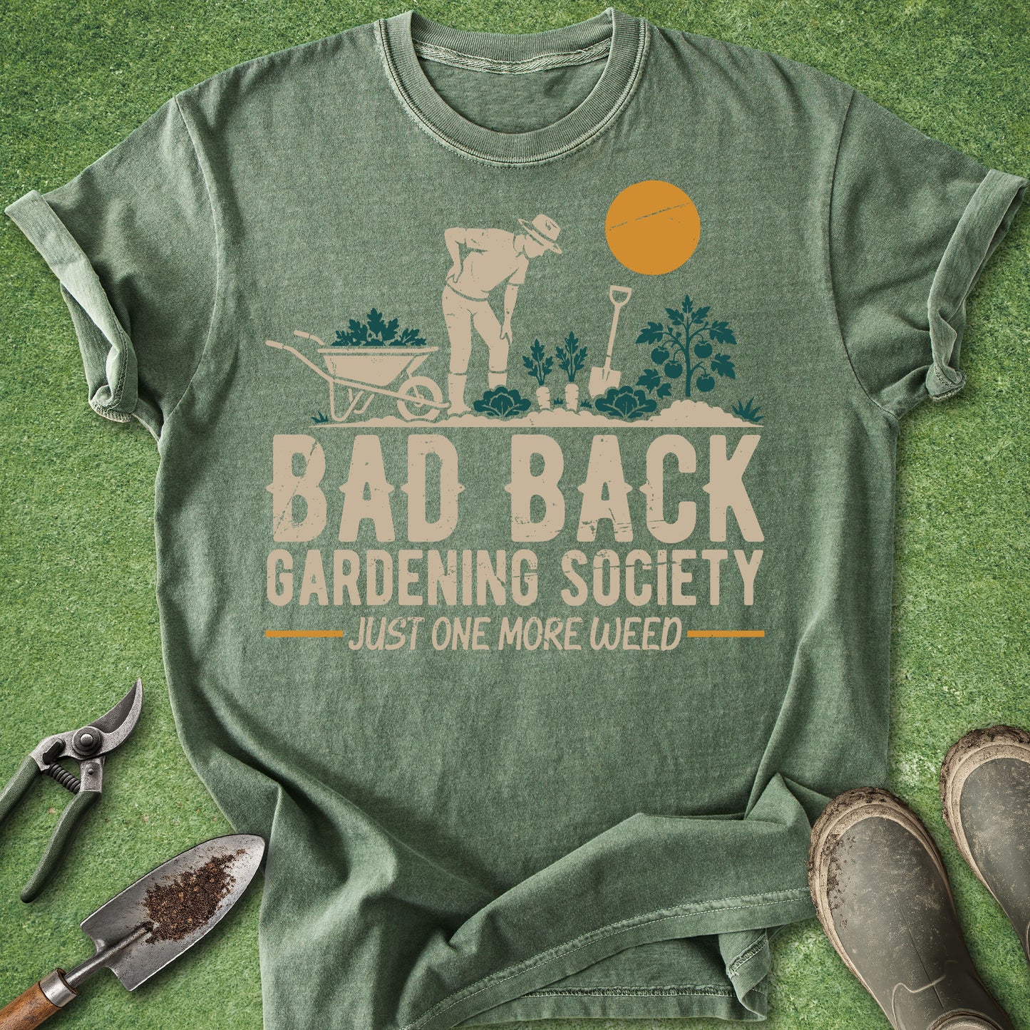 Green t-shirt with gardening graphic and text on a grass background