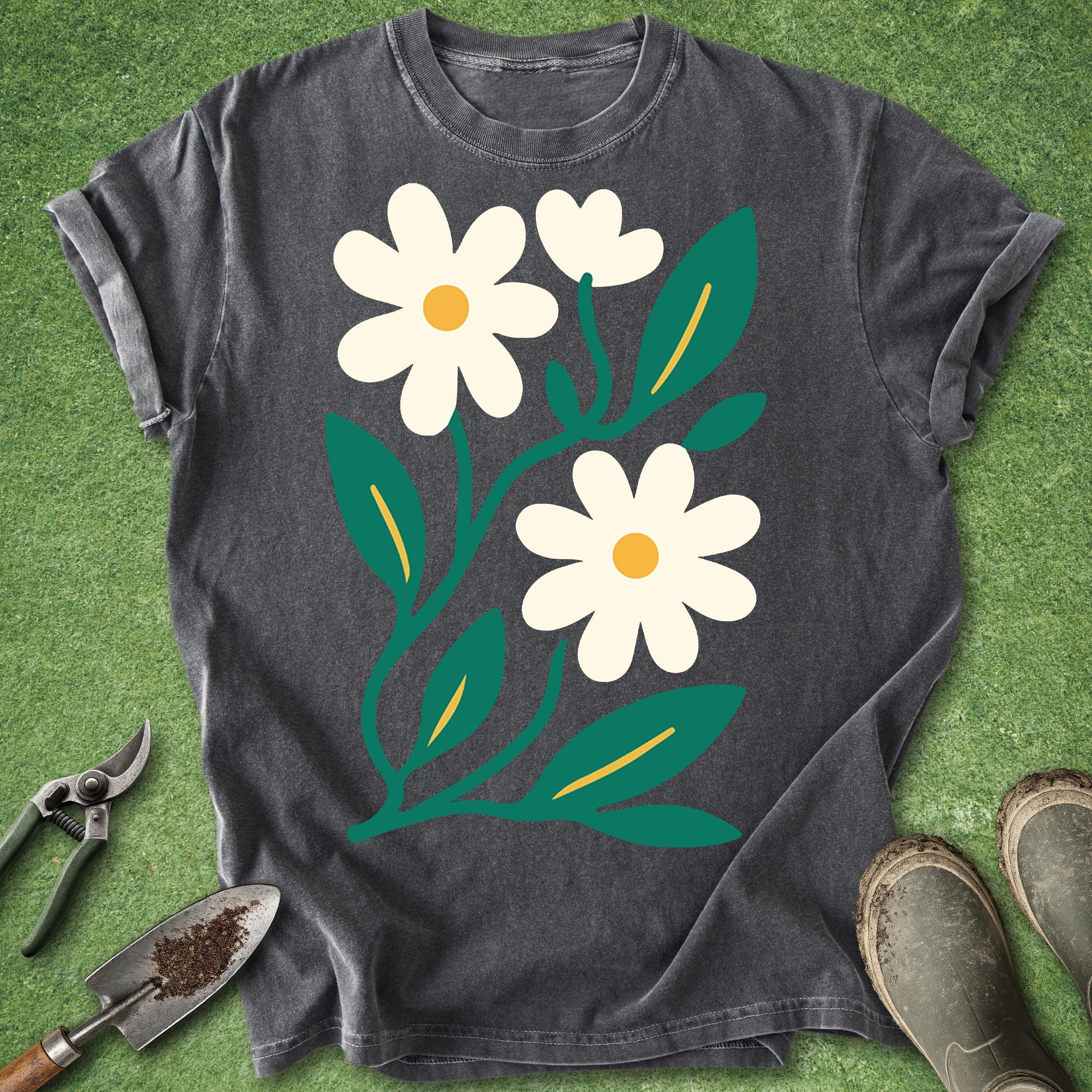 Dark gray t-shirt with white floral design on a green grass background