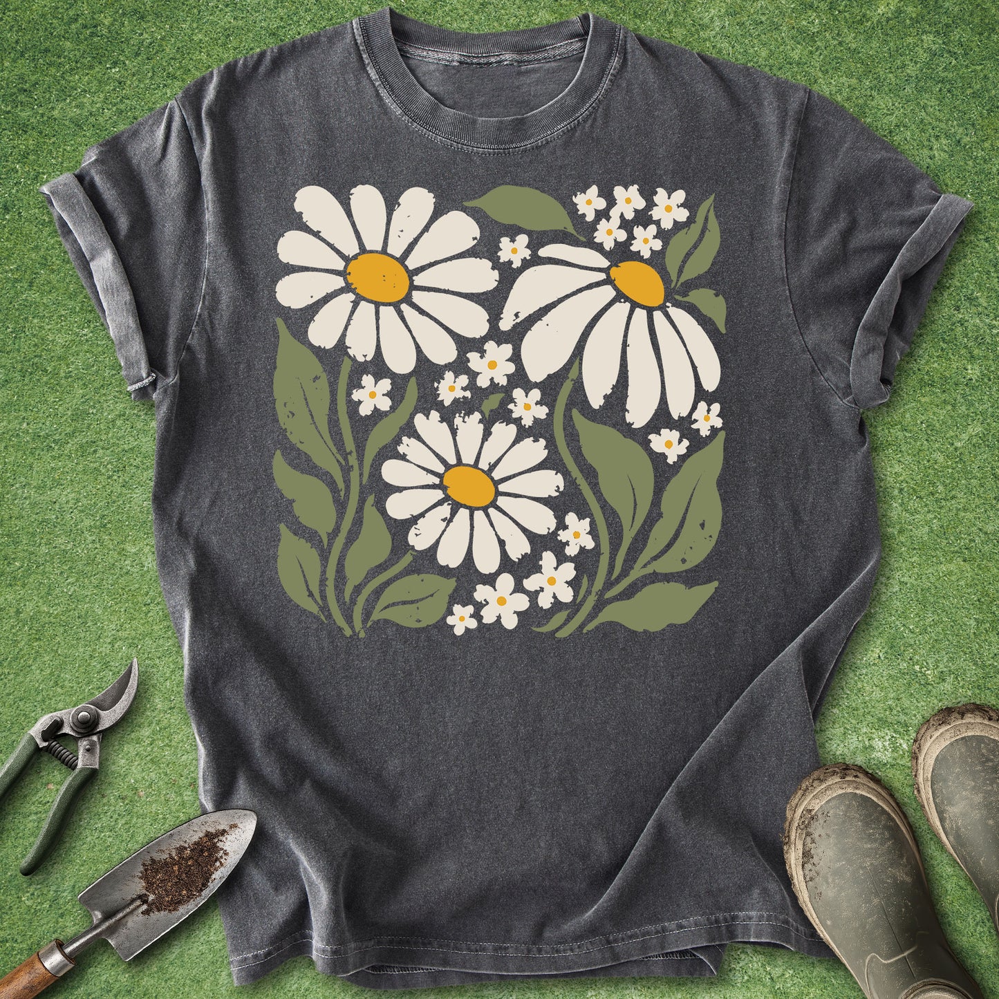 Dark gray t-shirt featuring a vintage boho illustration of three large white daisies with yellow centers surrounded by small white wildflowers and green leaves.