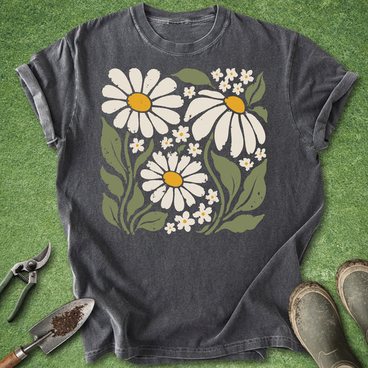 Dark gray t-shirt featuring a vintage boho illustration of three large white daisies with yellow centers surrounded by small white wildflowers and green leaves.