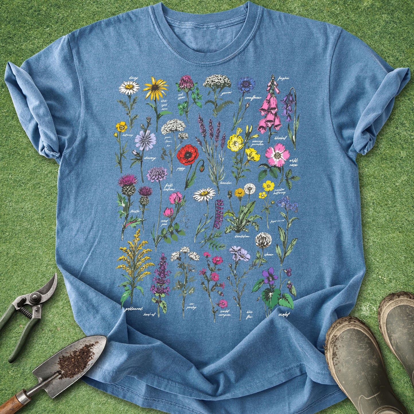 Blue t-shirt with floral design on a grass background
