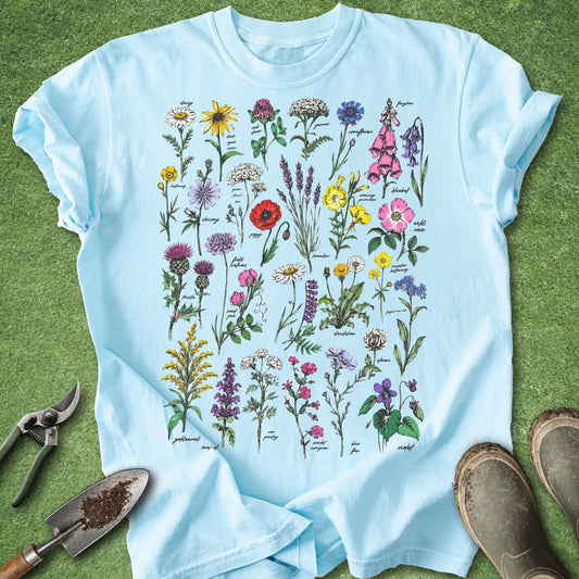 Light blue t-shirt with floral design on a grass background