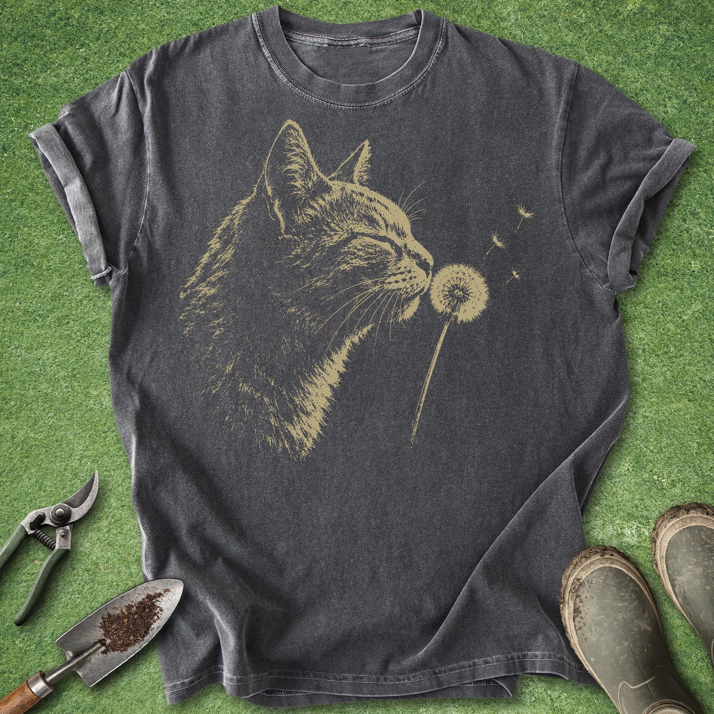 Gray t-shirt with a cat blowing dandelion design on a grass background