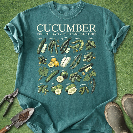 Teal t-shirt with cucumber illustrations on a grass background
