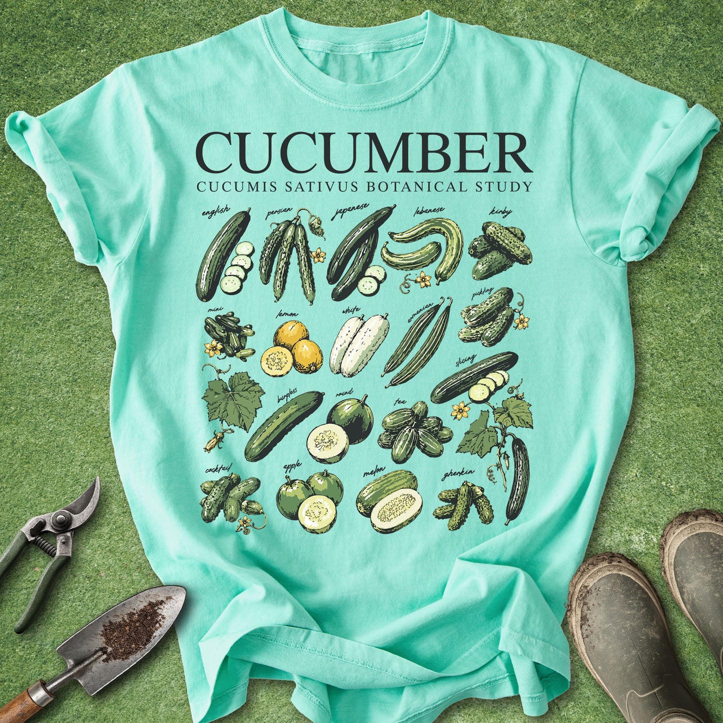 Teal t-shirt with cucumber graphic design on a green background