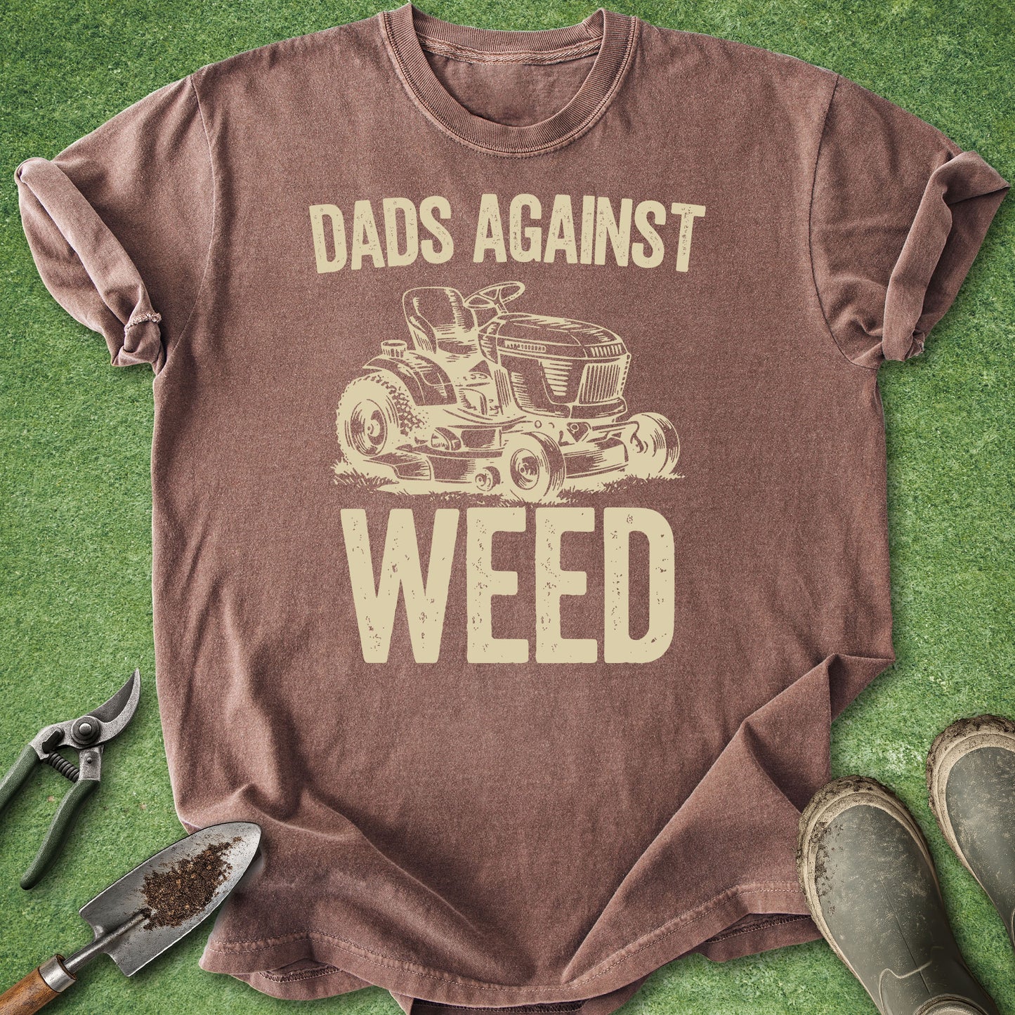 Brown t-shirt with 'Dads Against Weed' graphic on a grass background