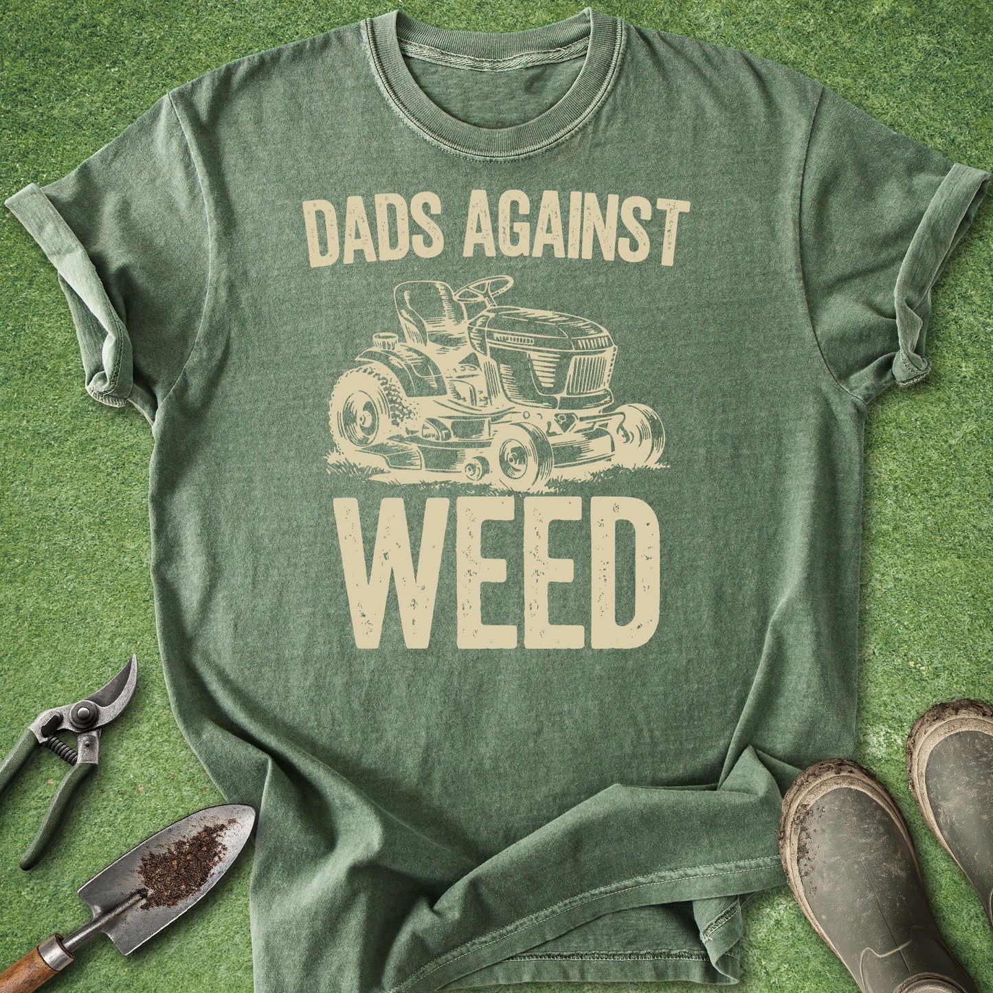 Green t-shirt with 'Dads Against Weed' graphic on a grass background