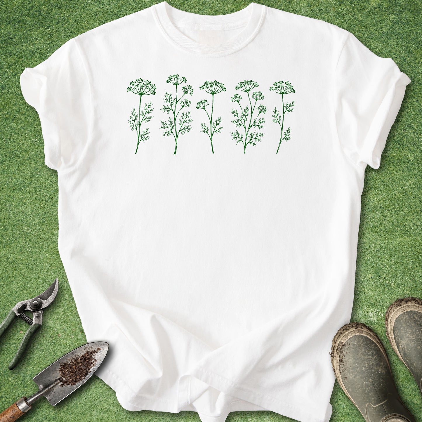 White t-shirt with green botanical design on a grass background
