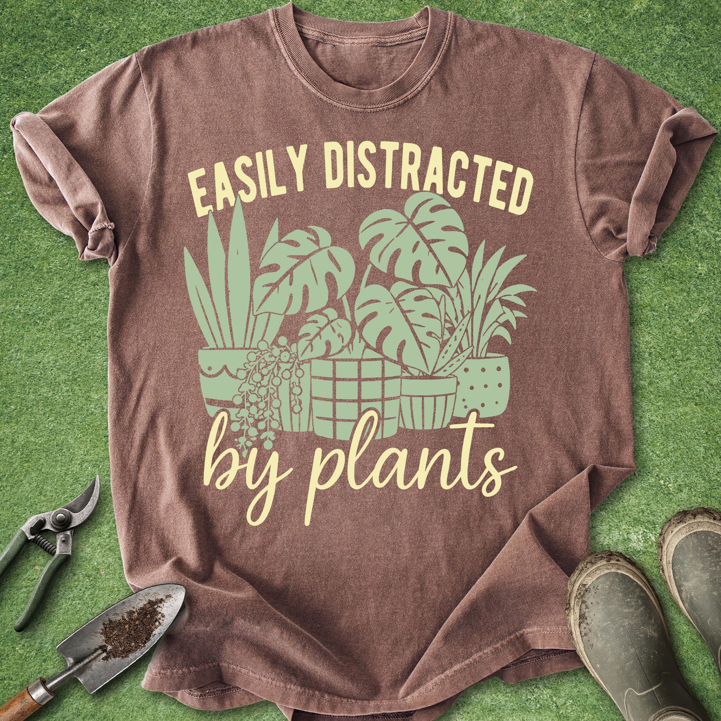 Brown t-shirt with plant-themed design and text on a green background