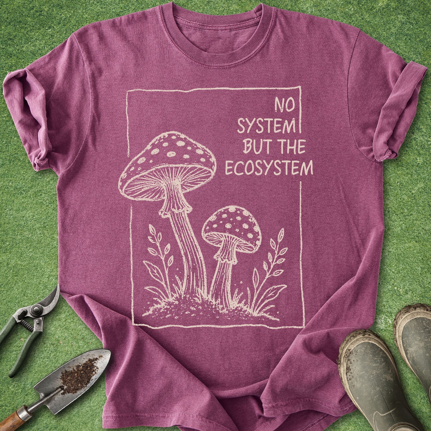 Purple t-shirt with mushroom design and text on a green background