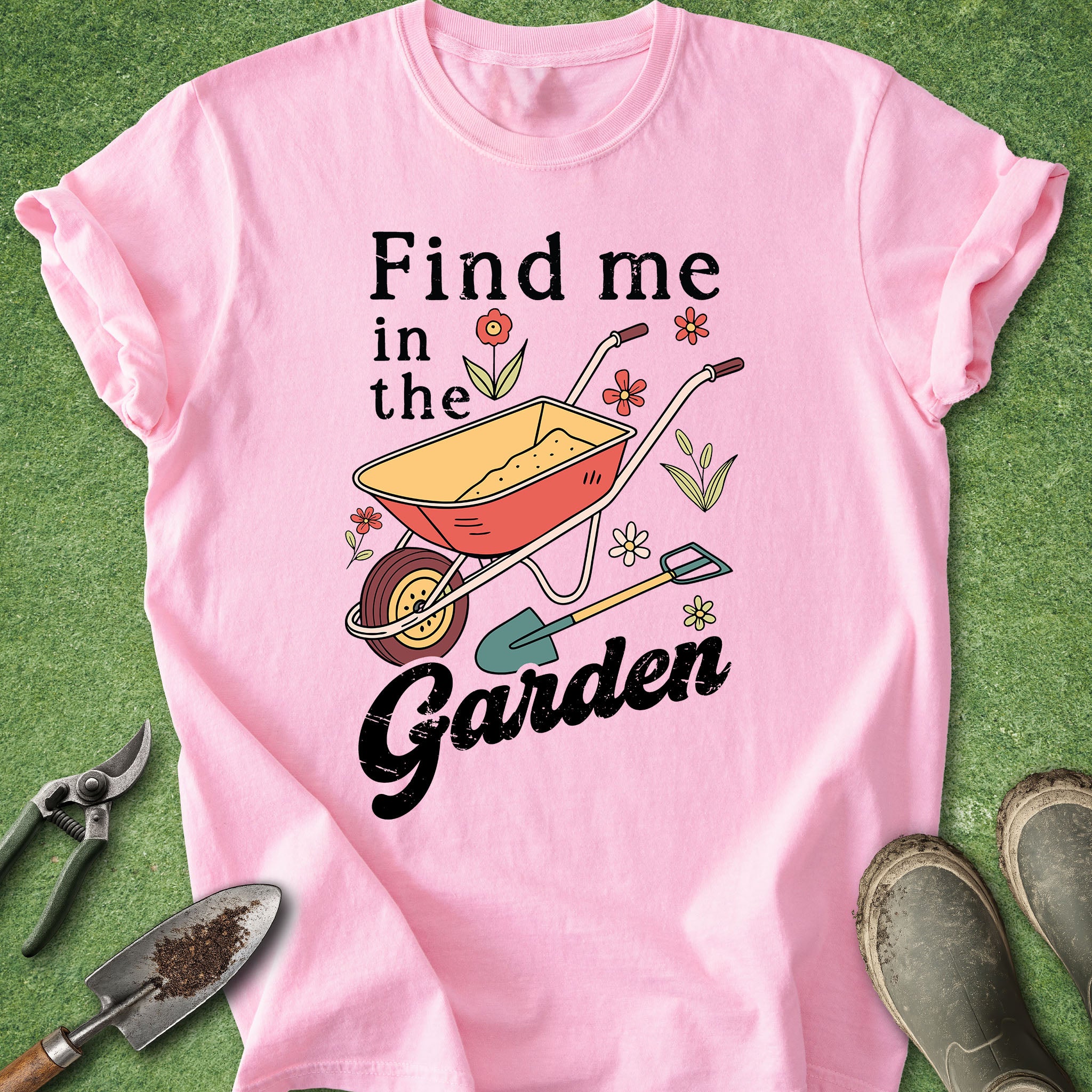 Pink t-shirt with garden-themed design on a green background