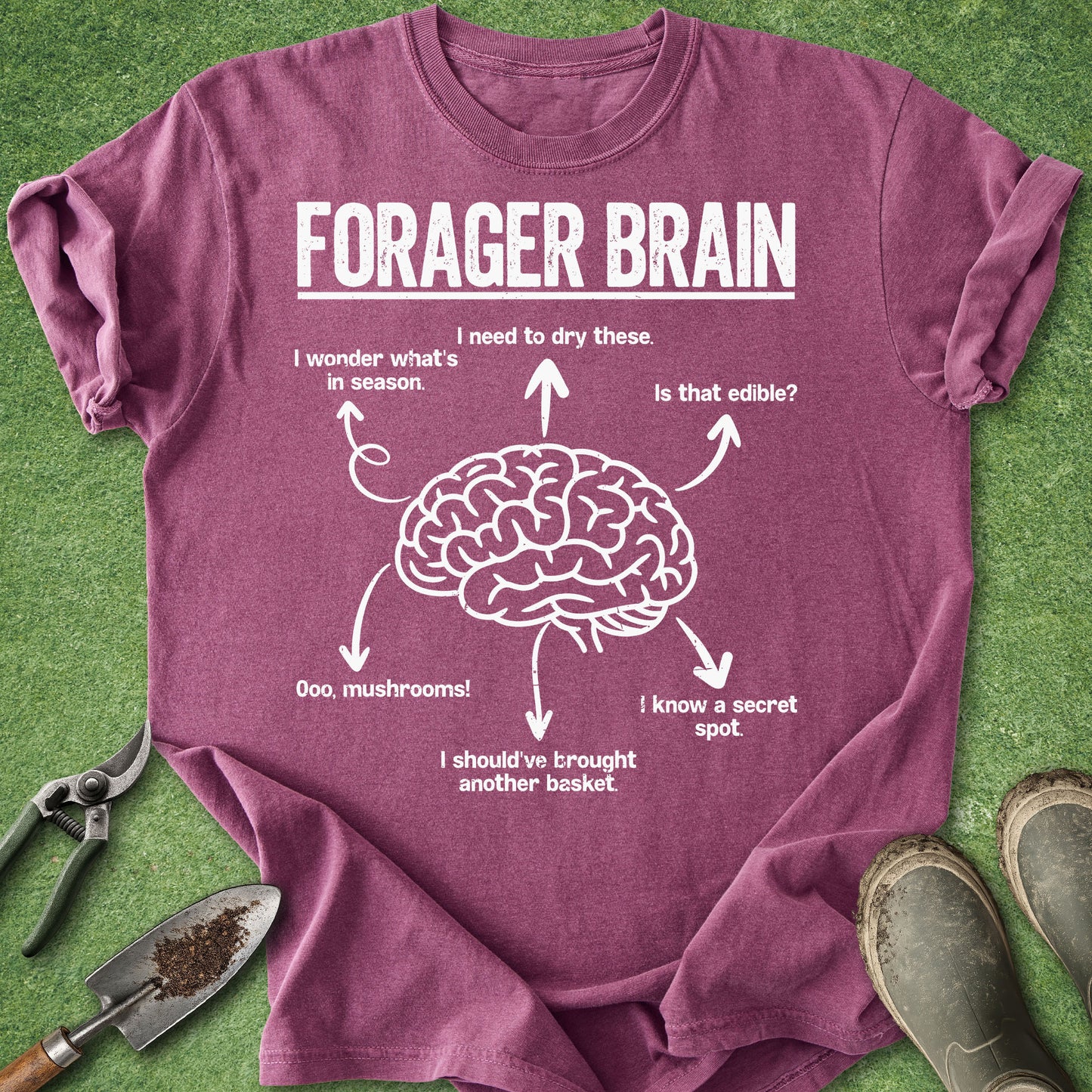Purple t-shirt with 'Forager Brain' graphic on a grass background