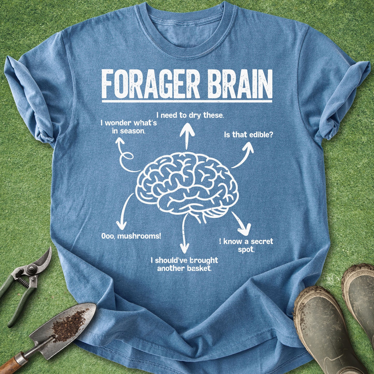 Blue t-shirt with 'Forager Brain' graphic on a grass background