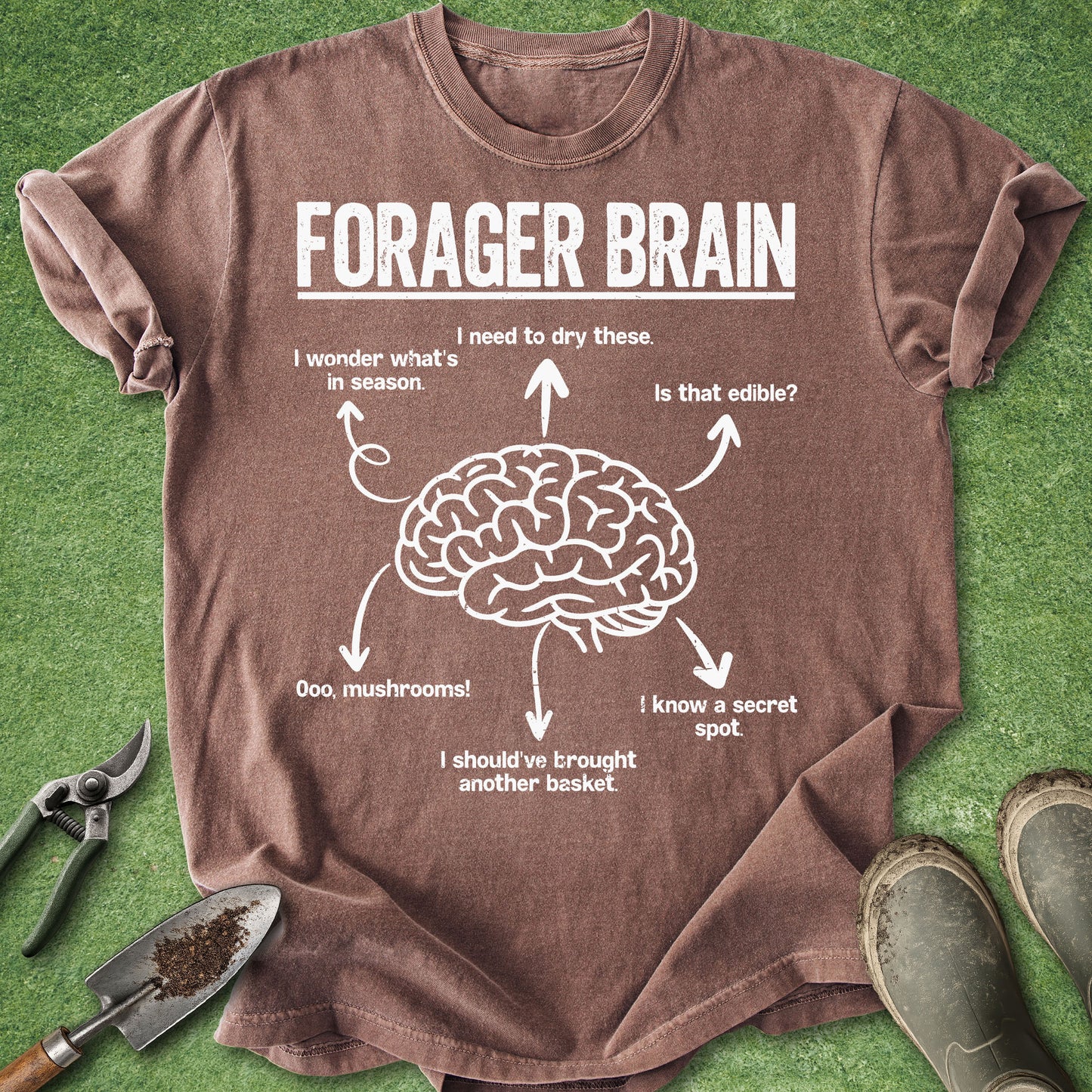 Brown t-shirt with 'Forager Brain' graphic on a green background with gardening tools.