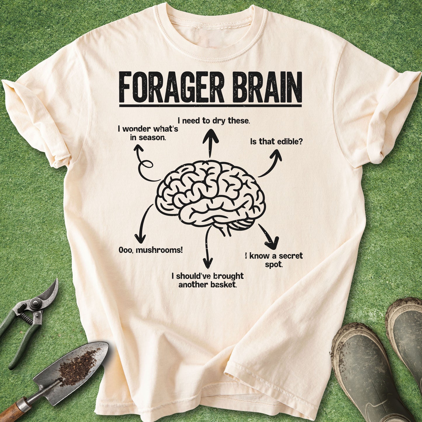 Beige t-shirt with brain graphic and text on a green background