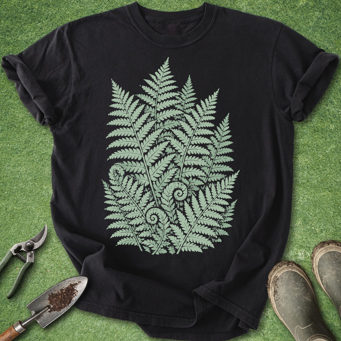 Black botanical t-shirt featuring a detailed cluster of forest ferns in soft sage green