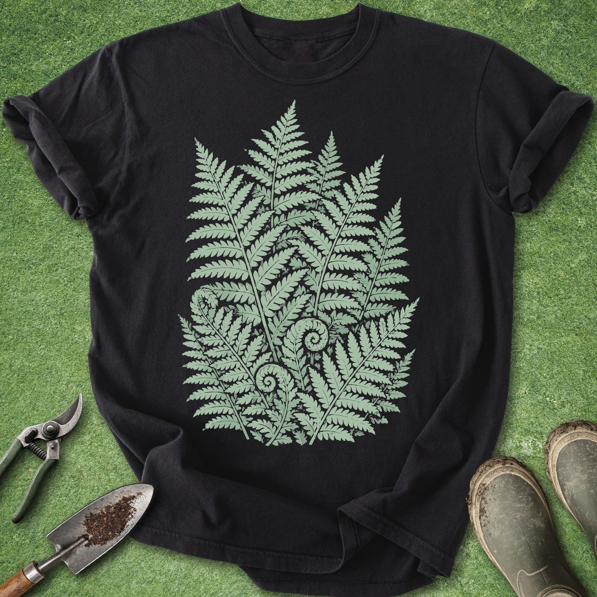 Black botanical t-shirt featuring a detailed cluster of forest ferns in soft sage green