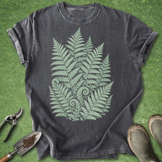 Dark gray t-shirt with green fern design on a grass background