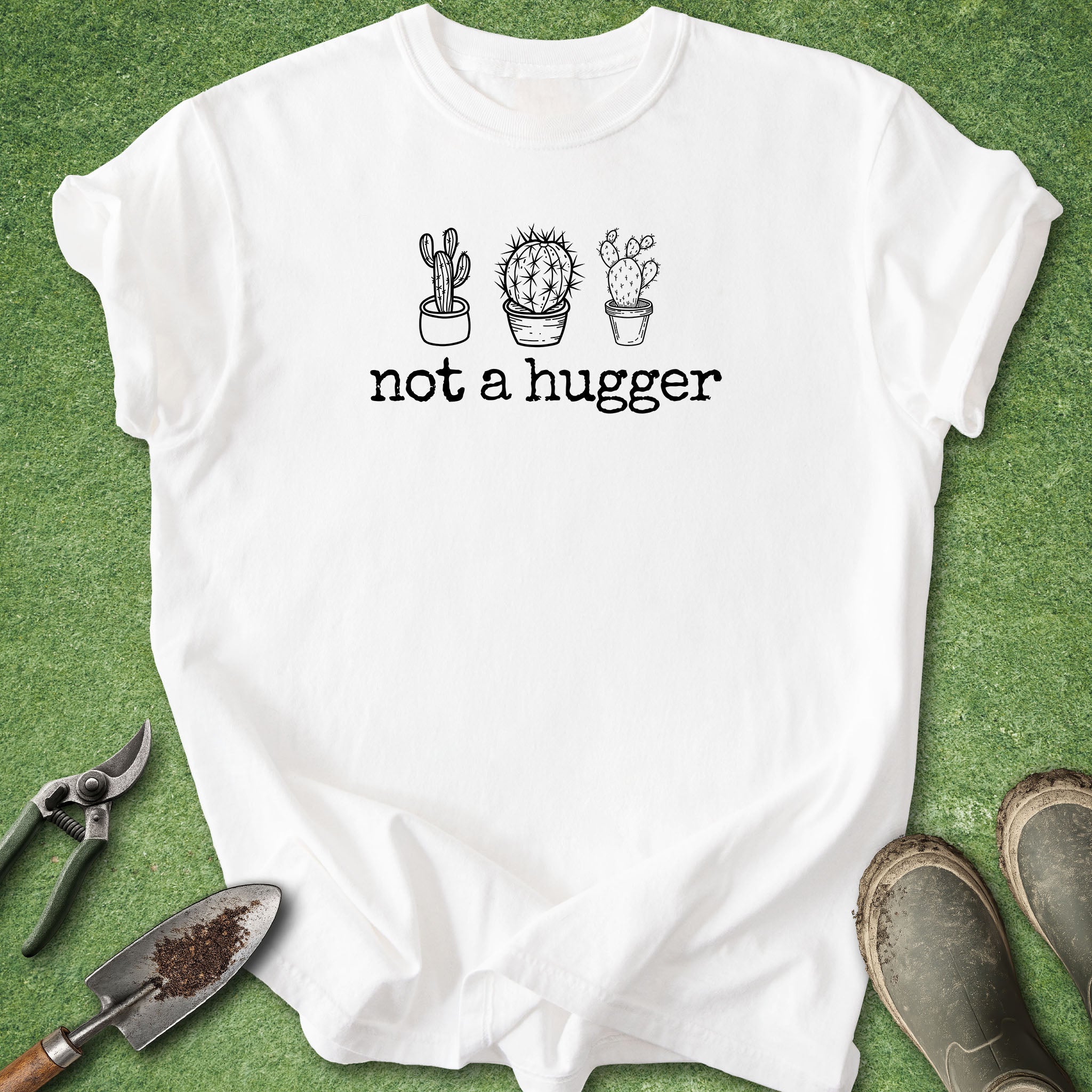 White t-shirt with cactus graphic and 'not a hugger' text on a green background