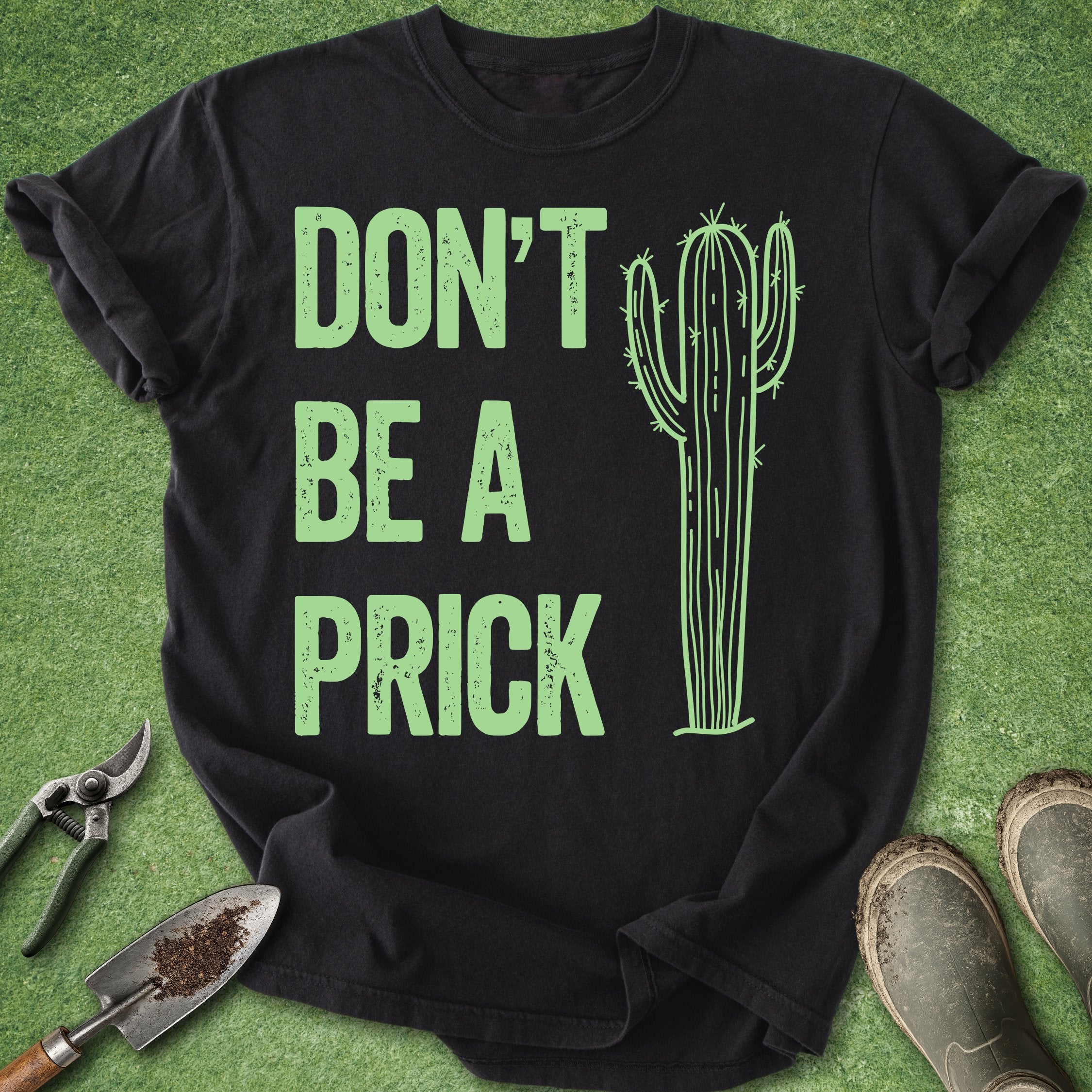 Black t-shirt with green cactus and text on a grass background