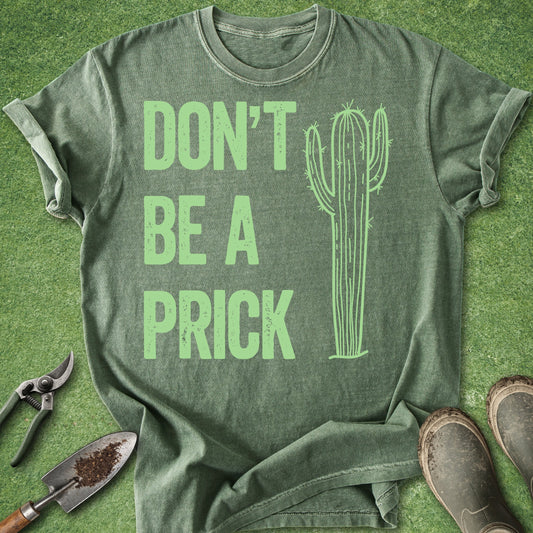 Green t-shirt with 'DON'T BE A PRICK' text and cactus graphic on a grass background