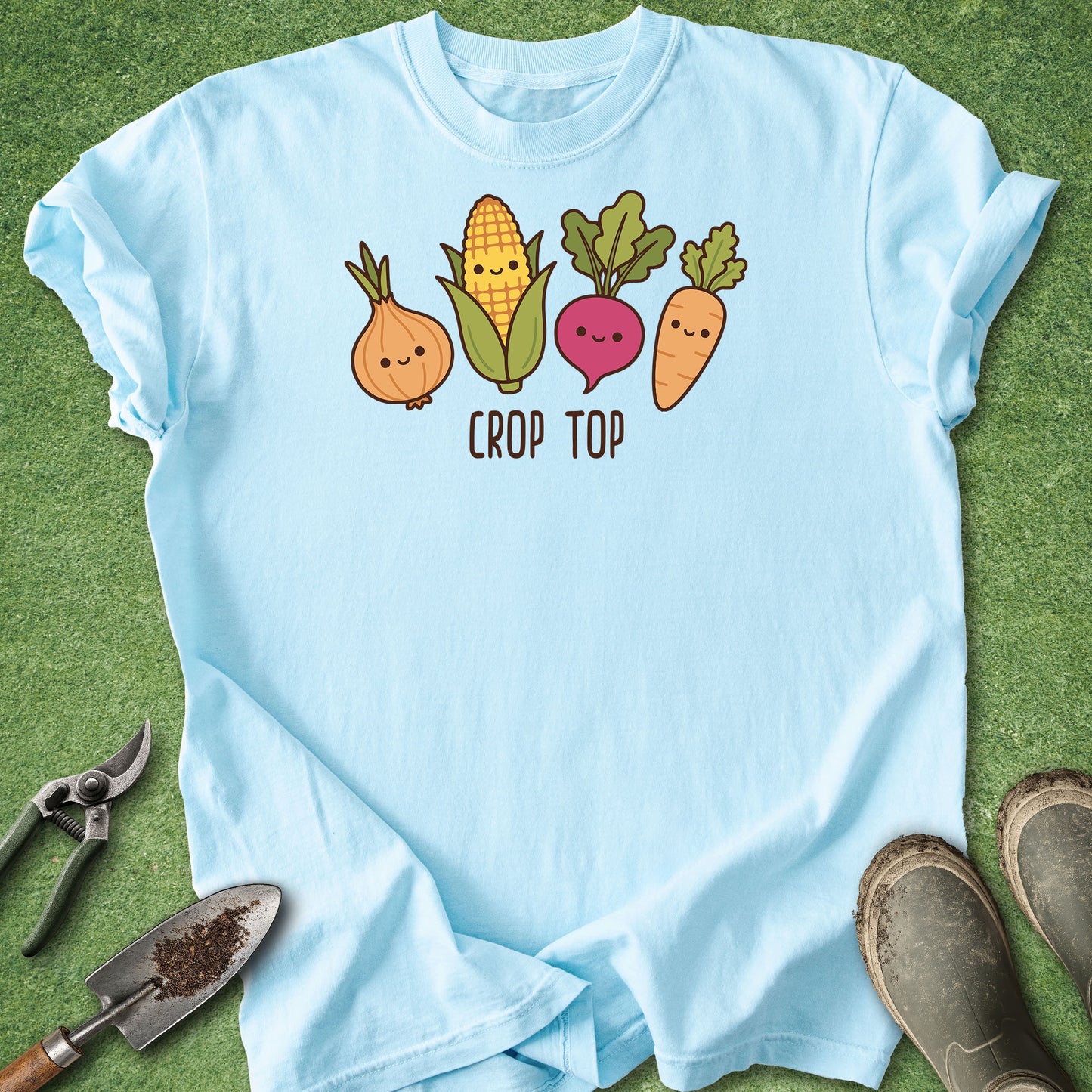 Light blue t-shirt with cartoon vegetables and 'Crop Top' text on a grass background