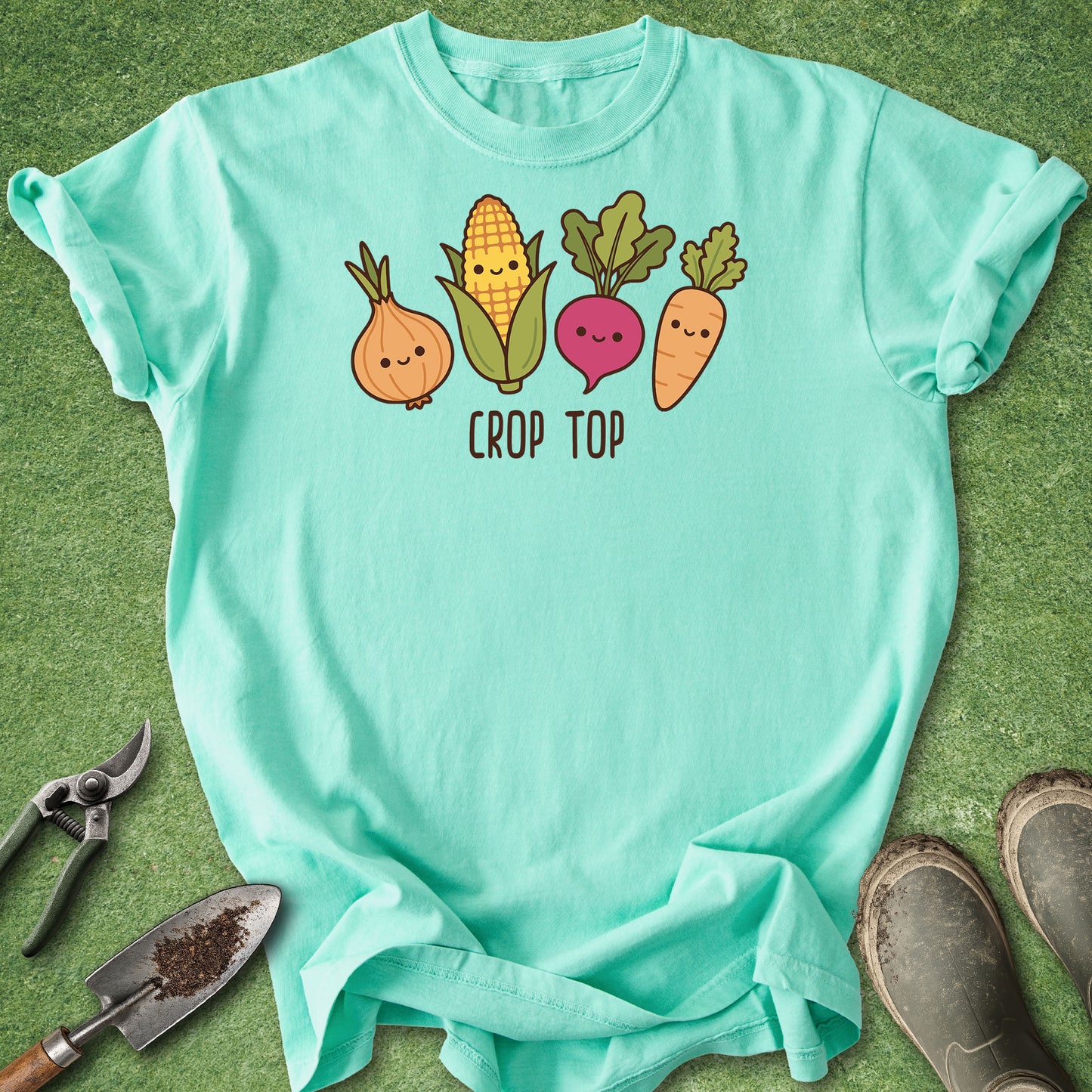 Mint green t-shirt with vegetable graphics and 'Crop Top' text on a grass background.