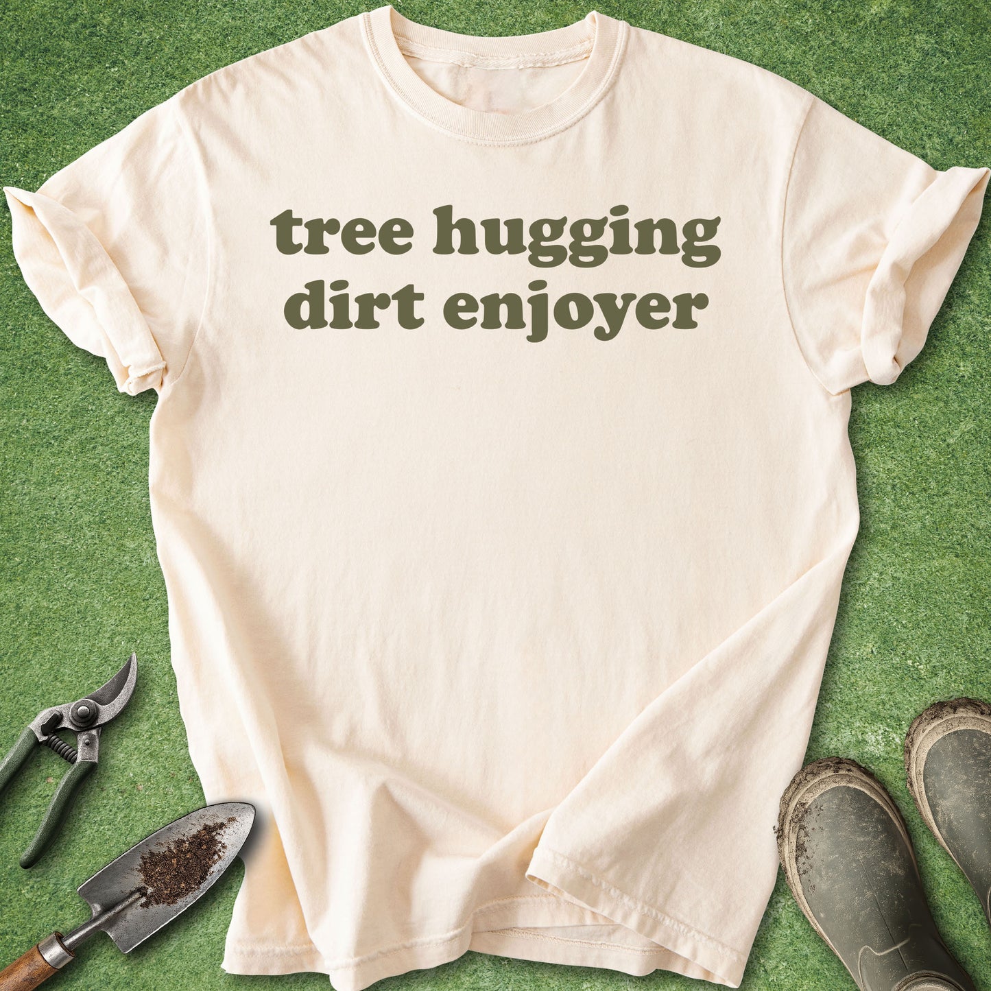 Minimalist funny gardening t-shirt reading “tree hugging dirt enjoyer” in retro green typography on ivory shirt