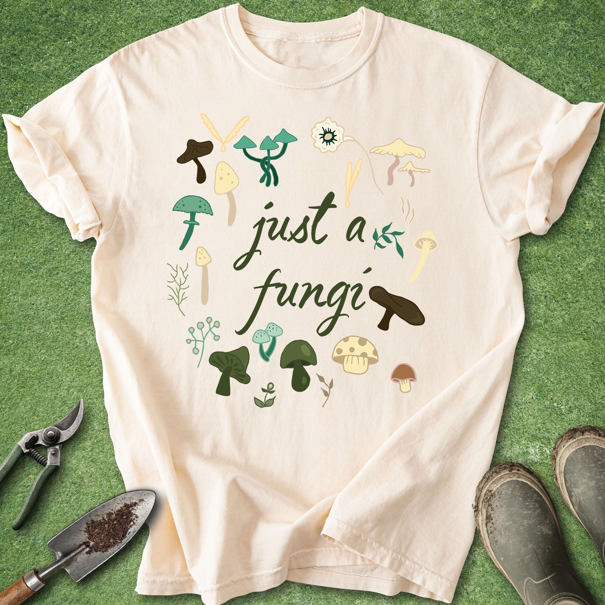 Ivory t-shirt with “just a fungi” text surrounded by illustrated mushrooms in a circular design
