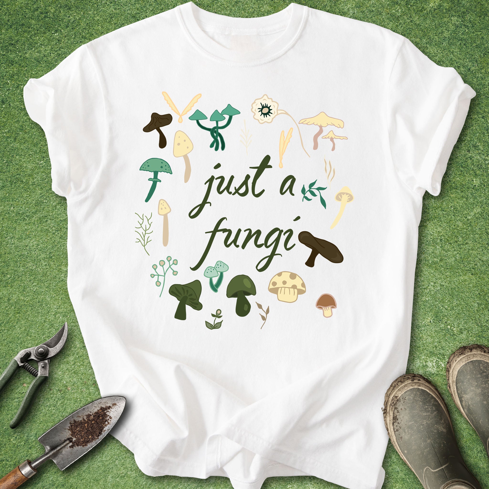 White t-shirt with mushroom design and text 'just a fungi' on a green background