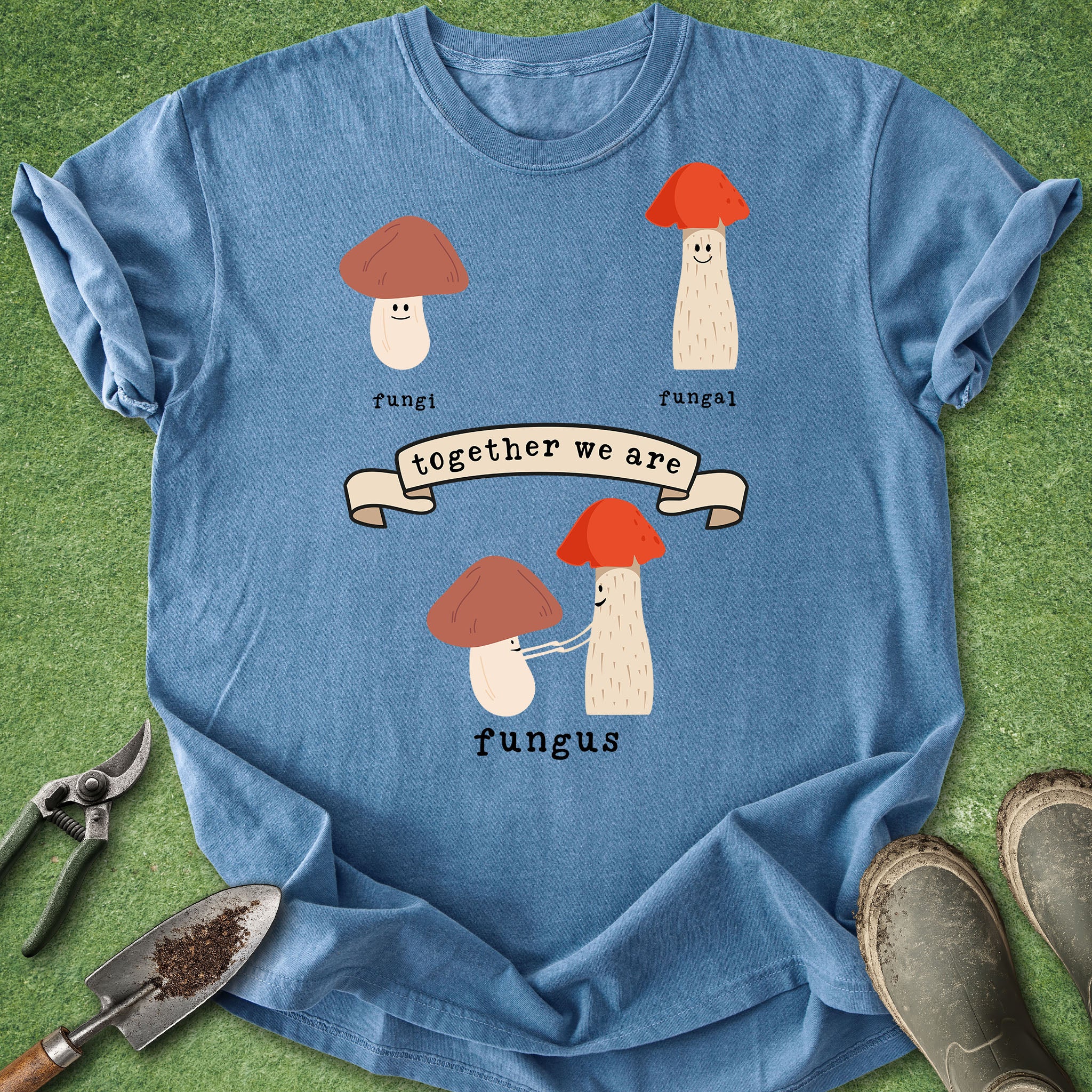 Funny mushroom pun t-shirt with cute illustrated fungi characters and the phrase "together we are fungus" on a teal shirt