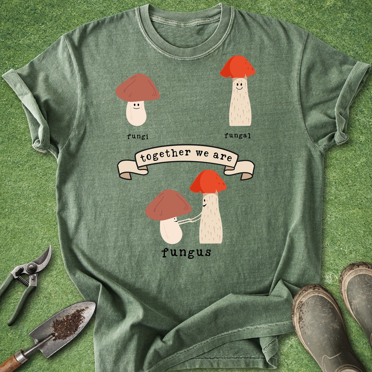 Green t-shirt with mushroom design and text on a grass background