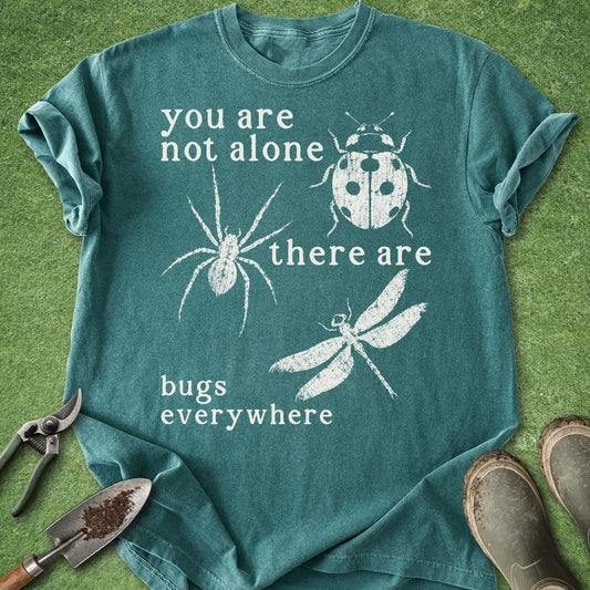 Funny gardening t-shirt with spider, ladybug, and dragonfly illustrations and “You are not alone there are bugs everywhere” quote on black shirt